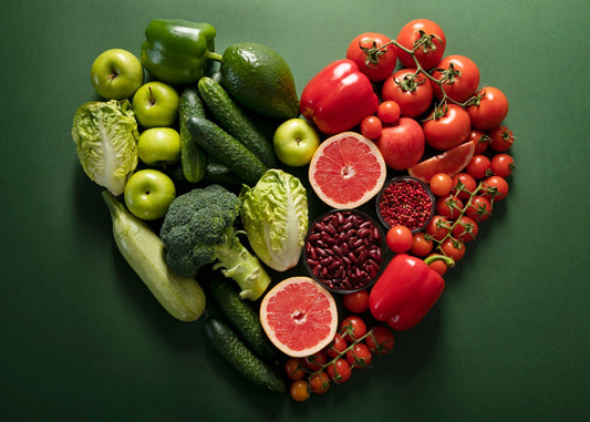 Organic fruits and vegetables arranged in a heart shape.